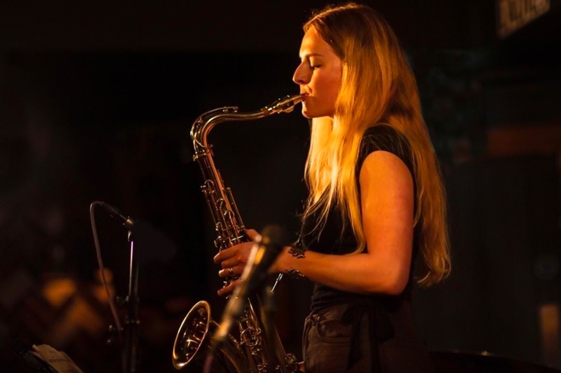 Colour photo of Maddy Combs playing saxophone